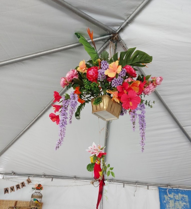 Vibrant tropical hanging basket with hibiscus and wisteria